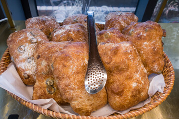 Fresh italian ciabatta bread with olive oil and olives.