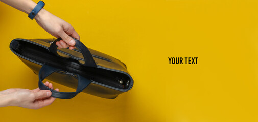 Female hands hold a leather bag