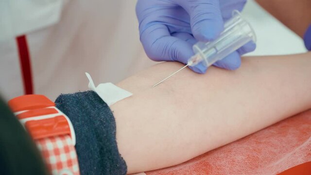 Syringe close up taking vein blood sample for heath test after undergoing coronavirus infection. Medicines research concept and defeating dangerous covid-19 infection
