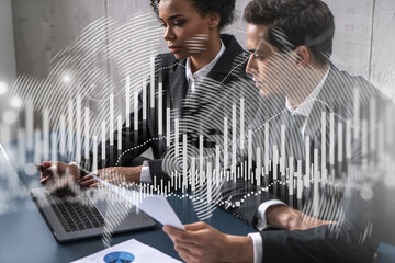 Two businesspeople working on market behavior. Trading concept. Forex graph. hologram.