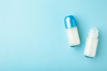 Different deodorants on blue background, top view. Skin care