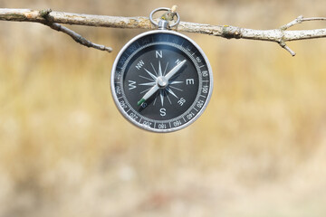 Classic navigation compass on natural background as symbol of tourism with compass, travel with compass and outdoor activities with compass