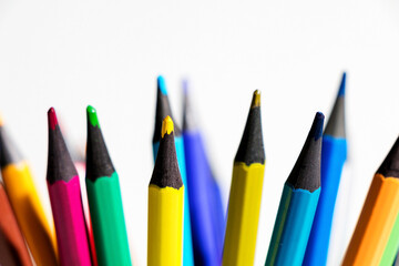 Set of colored pencils on white table