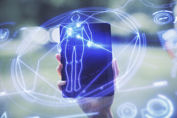 Double exposure of education theme sketch hologram and woman holding and using a mobile device.
