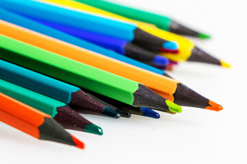 Set of colored pencils on white table