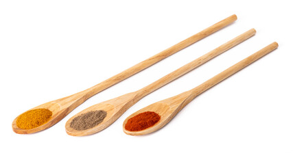 three spoons of different sizes made of natural wood with aromatic seasoning on a white isolated background