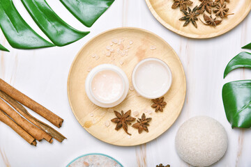 Natural skincare cream beauty product with spices oil, Cosmetic bottle containers packaging with green nature leaves, Blank label for organic spa branding mock-up, Herbal healthy skin care.