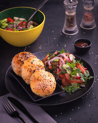 East Asian Dish Middle Eastern Cuisine Baked Samsa with meat served with salad on black table.Concept for menu for restaurant.