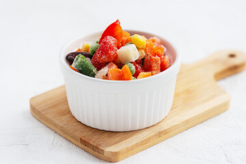 Frozen bell peppers, carrots, corn, peas, celery, onions and tomatoes in a white bowl.