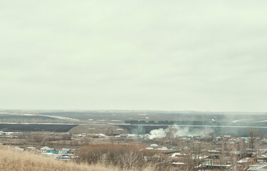 typical suburb near Moscow. Cottages, fields and forest belt aerial view. Early spring