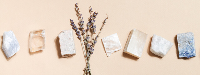 lavender and crystal minerals on beige background. magic rock for crystal ritual, witchcraft, spiritual practice and meditation. banner