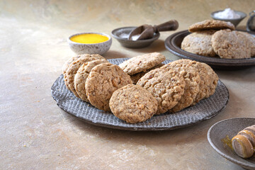 Shortbread cookies with almonds-Polvorones, a traditional Spanish sweet close-up. A saucer of honey and powdered sugar..