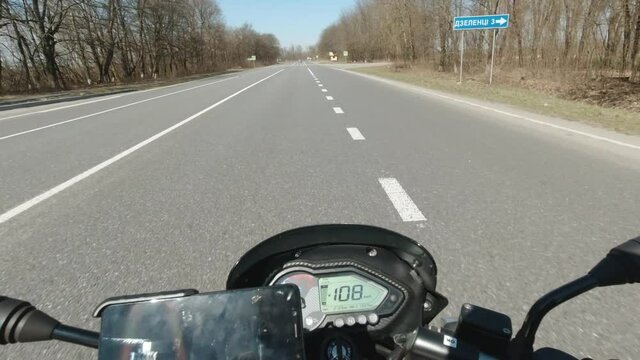 Motorcycle riding on the road, moto traveling at early spring, first person point of view, pov