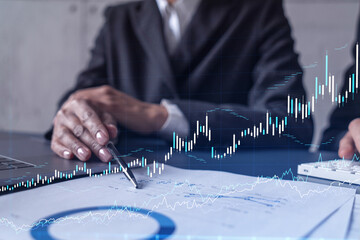 Two traders man and woman researching historic data to predict stock market behavior. Internet...