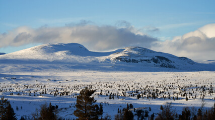Landscape of the winter mountains in &Aring;l, Hallingdal, Norway. Shot in April in the evening. Summer is coming, but the snow is still covering the mountains. 