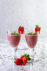 Strawberry banana smoothie. Strawberry dessert. Light gray background. Place for you text.