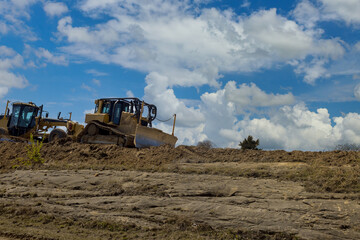 Under construction of a new road. The excavators, graders and road working on the construction site