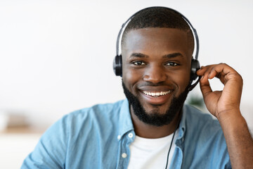 Call Center Operator. Closeup of friendly black man hotline manager in headset
