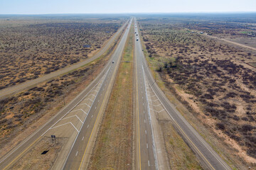 Fototapeta na wymiar Aerial view of long road through desert landscape towards near San Jon New Mexico USA