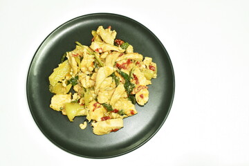 fried spicy chicken with basil leaf and chili on plate