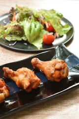 crispy fried chicken drum wing with barbecue sauce and vegetable on plate