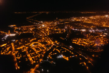 View of the Big Evening City from the window of an airplane appr