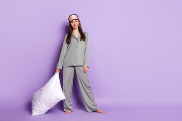 Full length body size view of attractive cheerful girl wear pajama carrying soft pillow bedtime...