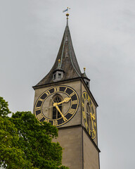 Saint Peter church clock tower under cloudy sky in Zurich, Switzerland