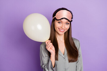 Photo portrait of dreamy woman in pajama keeping white air balloon isolated on pastel violet color background