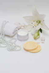 Plakat Lily (Lilium candidum) face cream with white towel, peals, Lilium fresh flower and sponges, isolated white