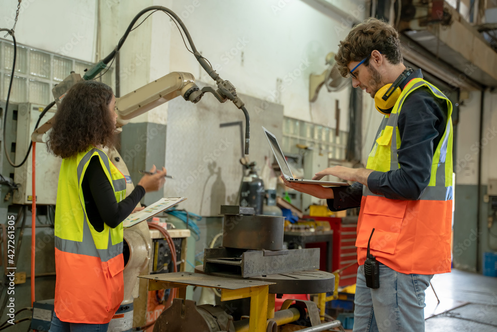 Fototapete engineer working and control robotic arm in manufacturing workshop,industry and engineering technolo
