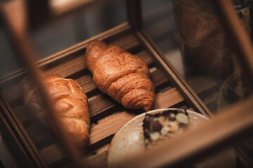 croissant bread dessert bakery in coffee cafe for breakfast, morning fresh meal food background in restaurant, French delicious brown dessert