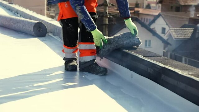 Waterproofing and insulation at construction site, waterproofing membrane preventing water penetration. Exterior vapor barrier for roof.