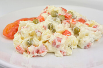 Homemade russian salad on white plate