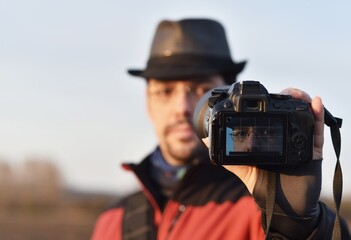 man takes a selfie photo on a dslr camera