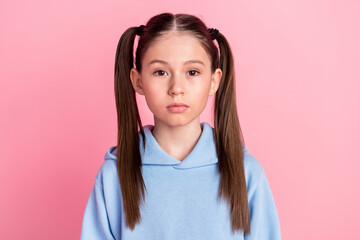 Portrait of nice attractive content cute serious preteen girl wearing cozy clothes isolated over pink pastel color background