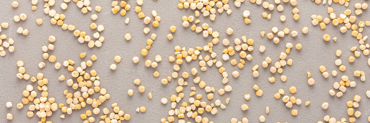 Legumes are scattered in the background, natural banner of yellow peas, top view