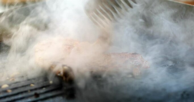 Close up footage of a slice of beef roasted on a barbecue grill.
