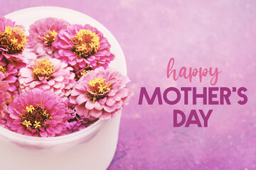 Mothers day holiday card with purple flowers on blurred background for holiday.