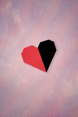 Origami heart floating over pink blurry background with copy space 