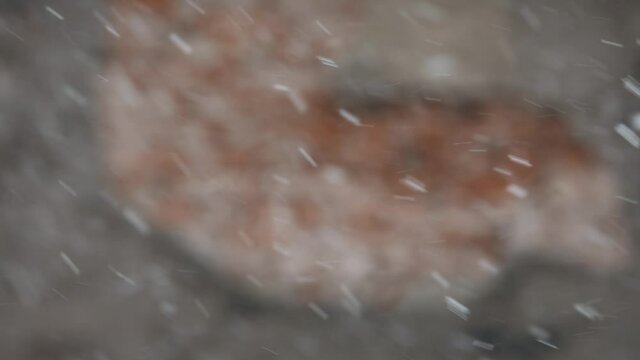 Footage of some falling snowflakes on a winter day.