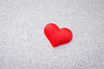 Close up shot of decorative heart on a white sparkled background. Love, feelings expression concept.