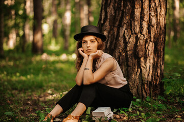 young girl relaxing in the Park with books