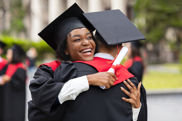 Happy african american couple students hugging, closeup