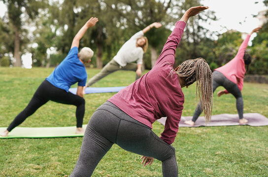 Multiracial people doing yoga at park with social distance for coronavirus outbreak