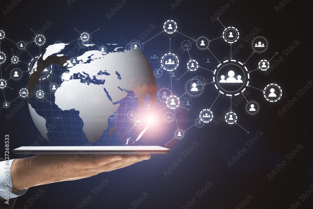 Poster Hand with a tablet holding the globe icon with muptiple small application icons near it on a dark background. Worldwide web and social communication concept