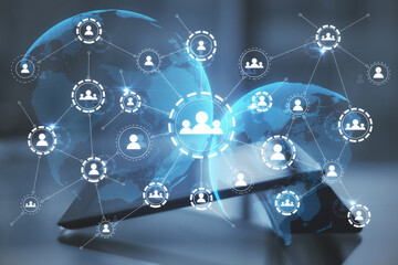 Multiple application hologram icons with a tablet in the background. Social media and communication concept, double exposure