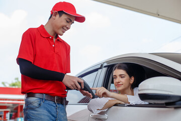 woman in car and paying press button of POS terminal spending instead of cash with man employee at...