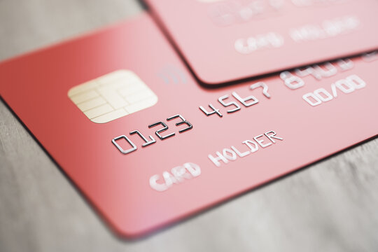 Online banking system concept with red credit cards on wooden surface