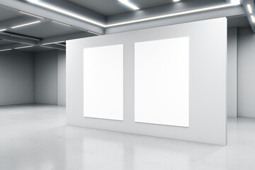 Empty big white room with a white concrete wall with two blank posters in the middle, artificially...